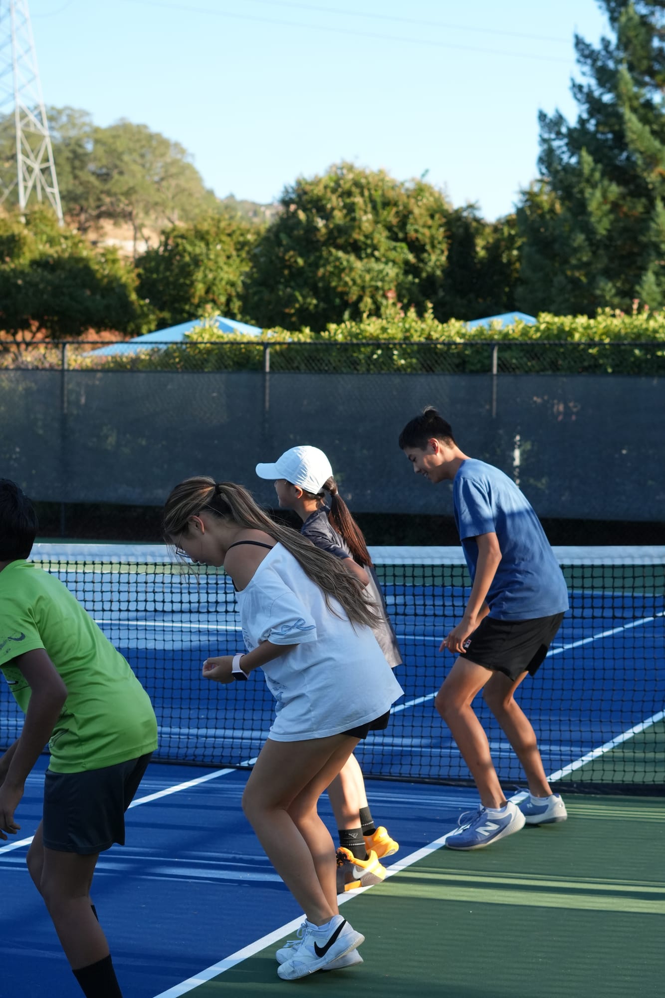 Players doing a group footwork drill on court during high-performance training